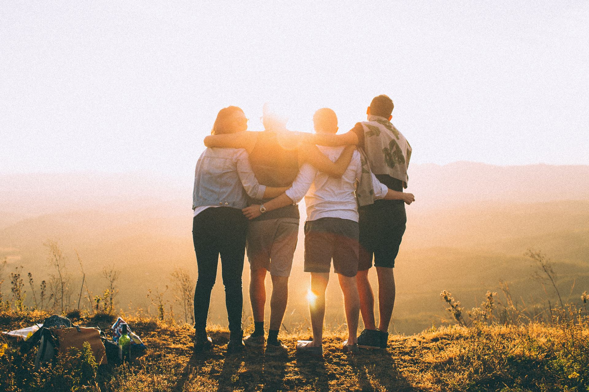 a group of people with their arms locked walking in the sun