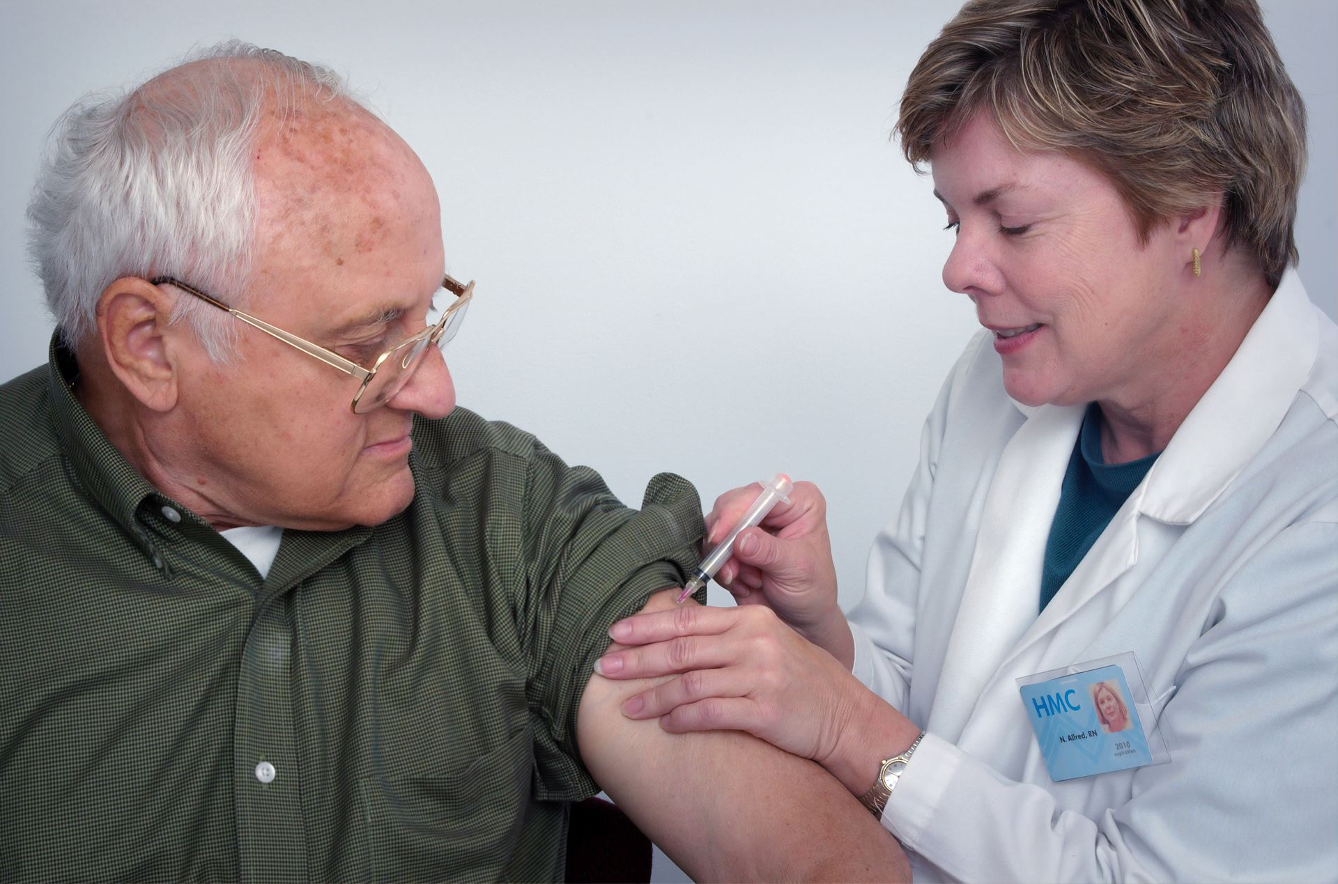 a clinician giving a vaccination to a patient