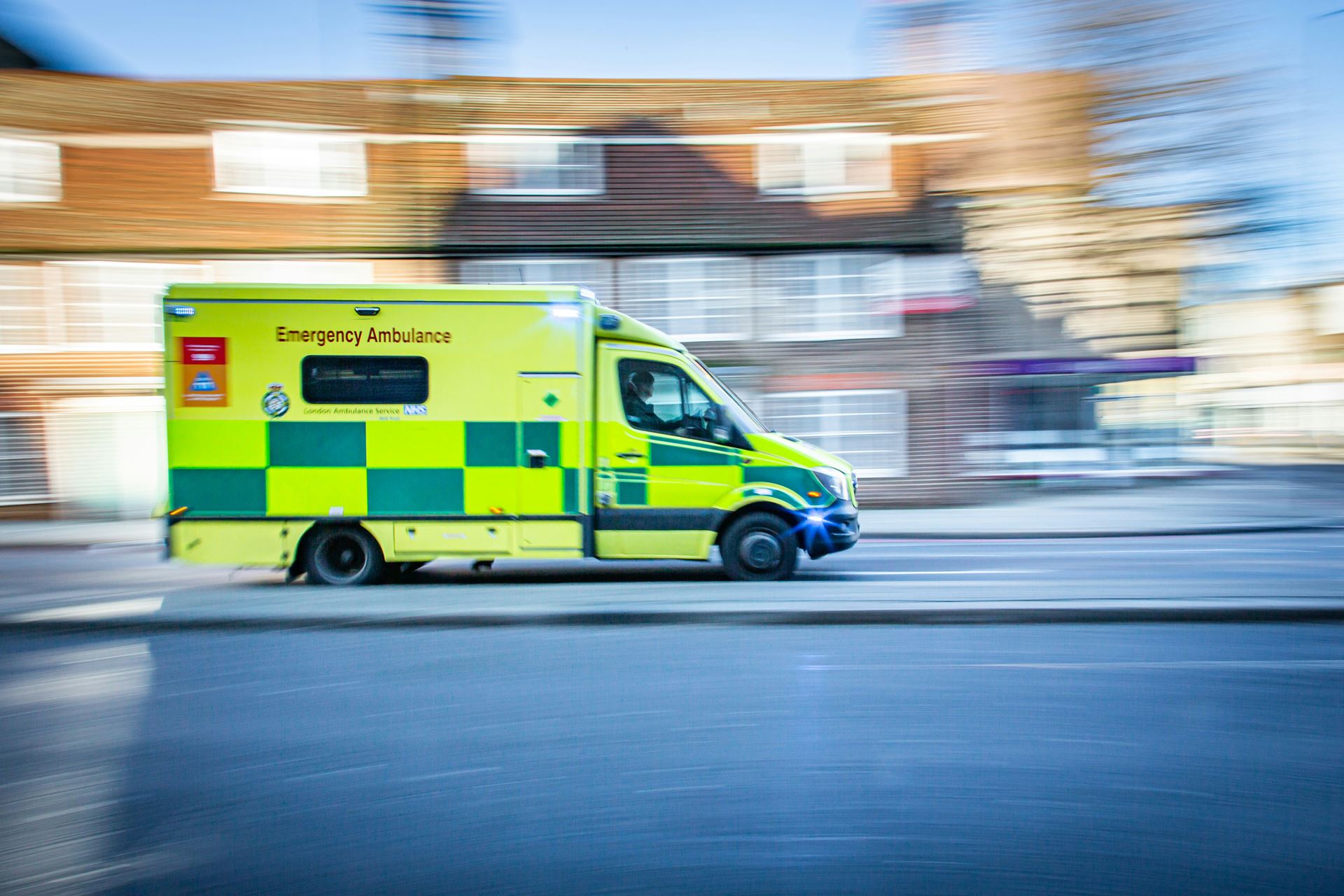 An emergency ambulance depicted driving quickly down a road
